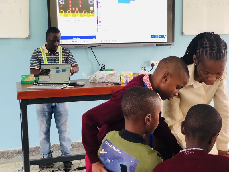 Teachers and students working together in the lab